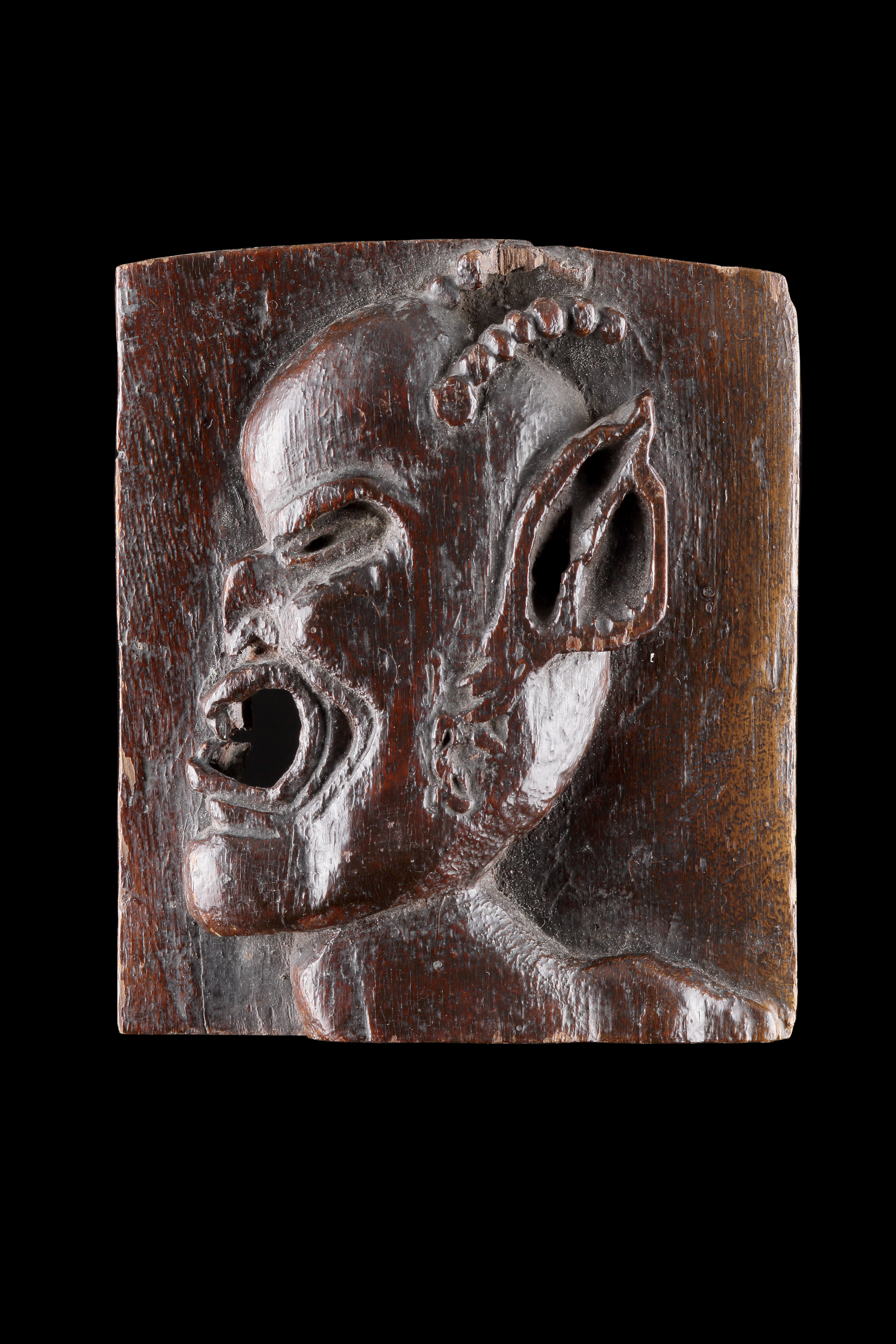 An Unusual Small Carved Plaque of a Horned Devil or ‘Demon’